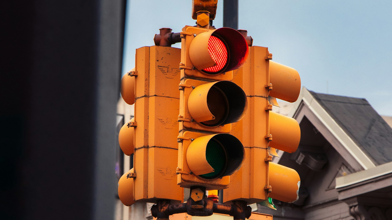 A red signal on a yellow traffic light.
